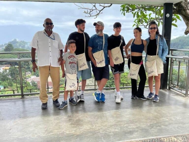 The Wildscape guide with a family group of guests at a hillside viewpoint overlooking the surrounding hills